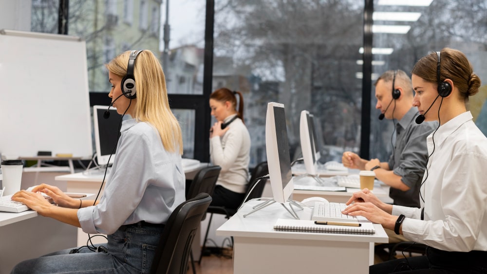 Customer service representatives wearing headsets, providing professional call center services and solutions to businesses in the UK.